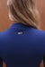 Blue jacket with 'SET' logo on the back, worn by a person with blonde hair.