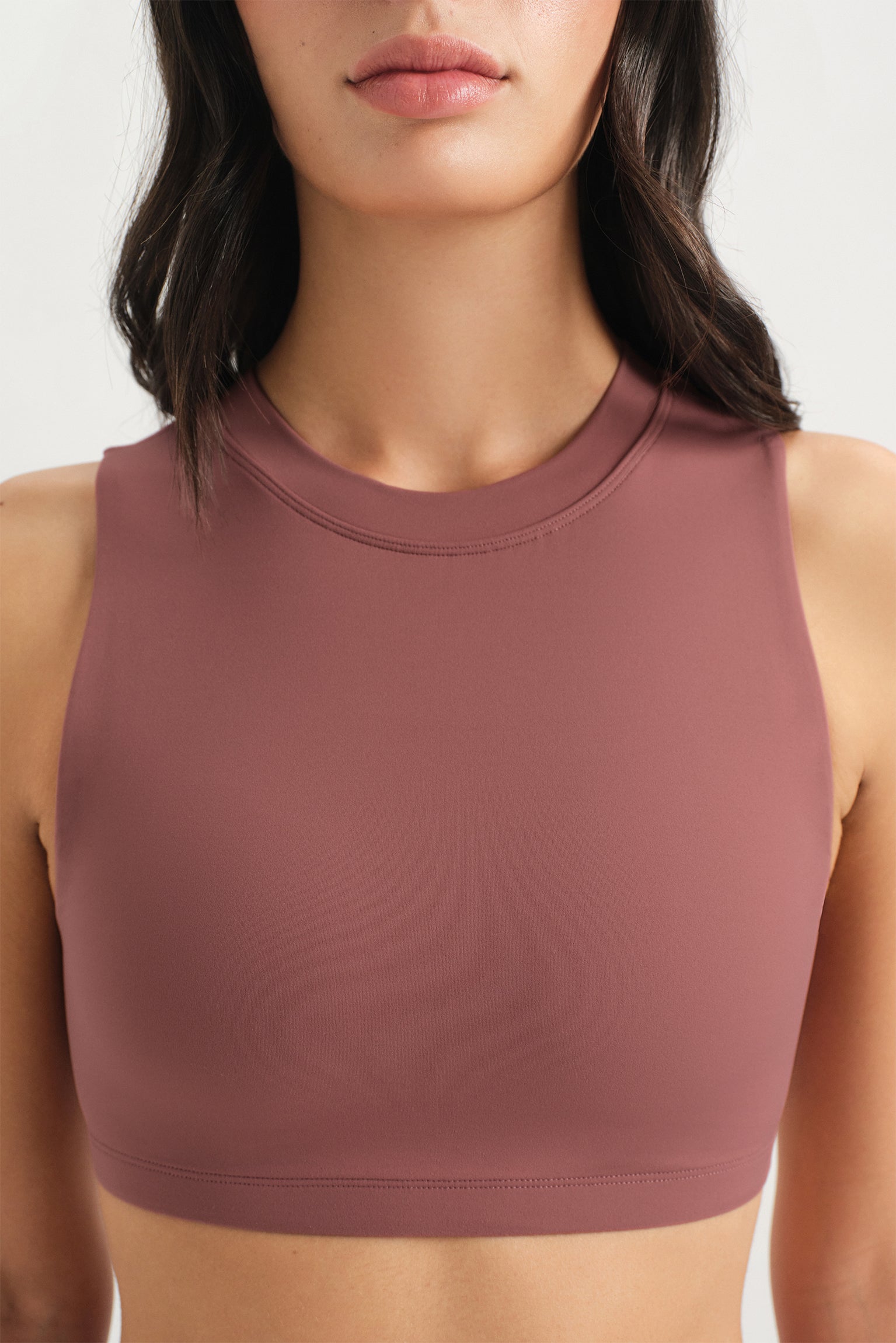 Brown sports bra worn by a person on a white background