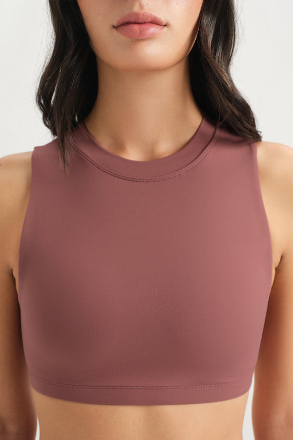Brown sports bra worn by a person on a white background