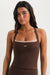 Woman wearing a brown tank top with 'SET' logo on a white background <model-info>Sydnee wears a size XS and is 5'8", 22” waist, 32BB bust.</model-info>