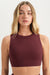 Woman wearing a maroon sports bra against a plain background <model-info>Grace wears a size XS and is 5'8", 25" waist, 32" bust.</model-info>