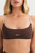 Brown bra with 'SET' logo worn by a model on a plain background