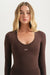 Woman wearing a brown long-sleeve top with 'SET' logo on a white background <model-info>Grace wears a size XS and is 5'8", 25" waist, 32" bust.</model-info>