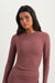 Woman wearing a mauve long-sleeve top against a white background <model-info>Sydnee wears a size XS and is 5'8", 22” waist, 32BB bust.</model-info>