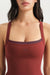 Red tank top worn by a person on a plain background