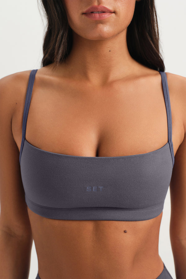 Gray sports bra with 'SET' branding on a plain background