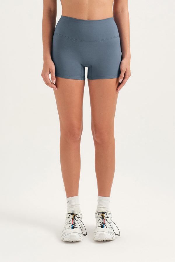 Person wearing gray athletic shorts on a white background 