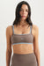 Woman wearing a brown sports bra and leggings with 'SET' branding on a white background <model-info>Casey wears a size S and is 5’9”, 24” waist, 32B bust.</model-info>