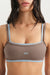 Brown sports bra with blue straps and 'SET' logo on a neutral background