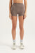 Person wearing brown athletic shorts on a white background <model-info>Casey wears a size S and is 5’9”, 24” waist, 32B bust.</model-info>