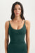 Woman wearing a green tank top with a brand logo on a white background <model-info>Casey wears a size S and is 5’9”, 24” waist, 32B bust.</model-info>