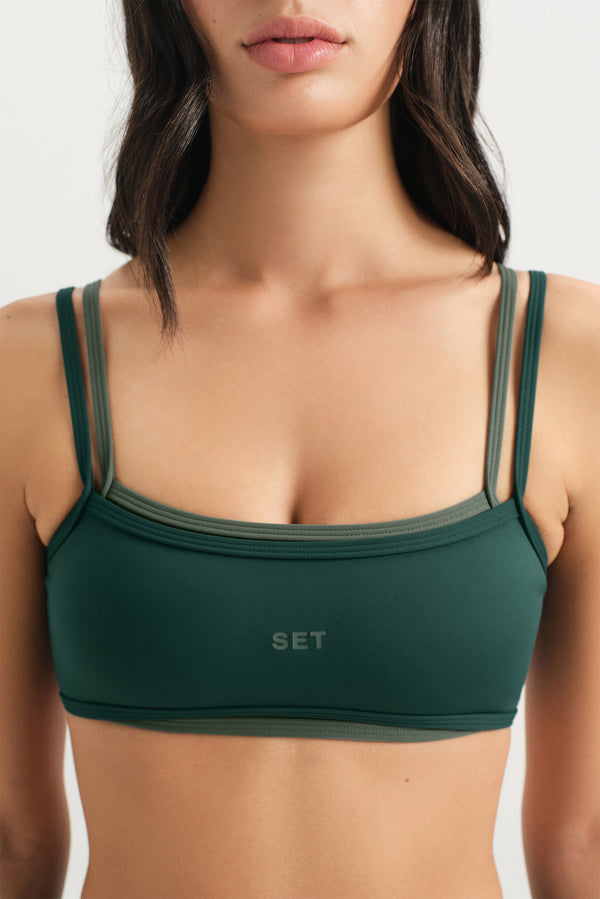 Green sports bra with 'SET' branding on a white background