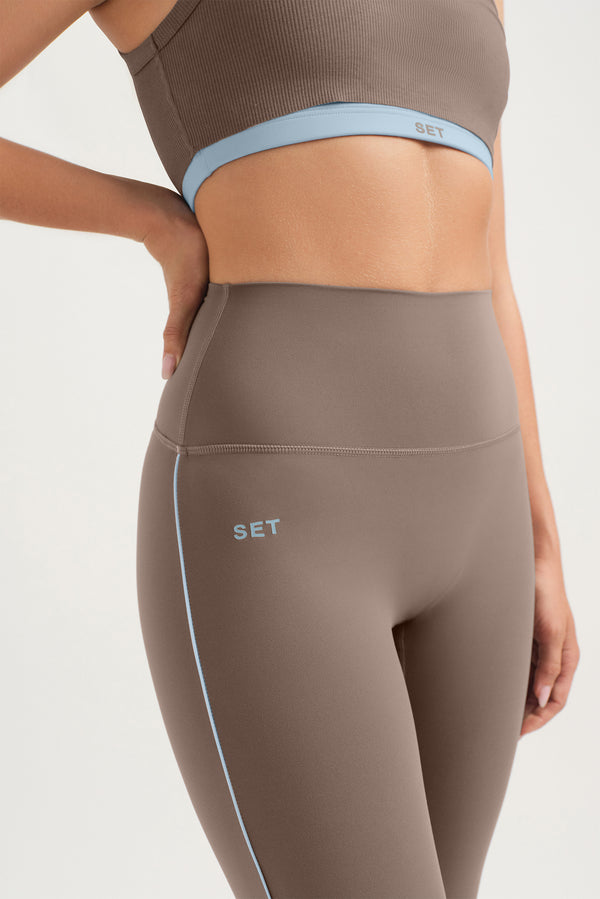 Brown athletic outfit with 'SET' branding on a light background