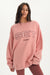 Woman wearing a pink sweatshirt with 'SET Sport' text on a white background <model-info>Jelene wears a size L and is 5’7”, 23” waist, 32AB bust.</model-info>
