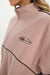 Close-up of a pink fleece pullover with a logo on a white background