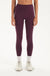 Woman wearing a purple leggings on a white background <model-info>Jelene wears a size XS and is 5’7”, 23” waist, 32AB bust.</model-info>