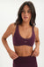 Woman wearing a purple sports bra and leggings with 'SET' branding on a white background <model-info>Jelene wears a size XS and is 5’7”, 23” waist, 32AB bust.</model-info>