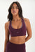 Woman wearing a purple sports bra and leggings with 'SET' branding on a white background <model-info>Jelene wears a size XS and is 5’7”, 23” waist, 32AB bust.</model-info>