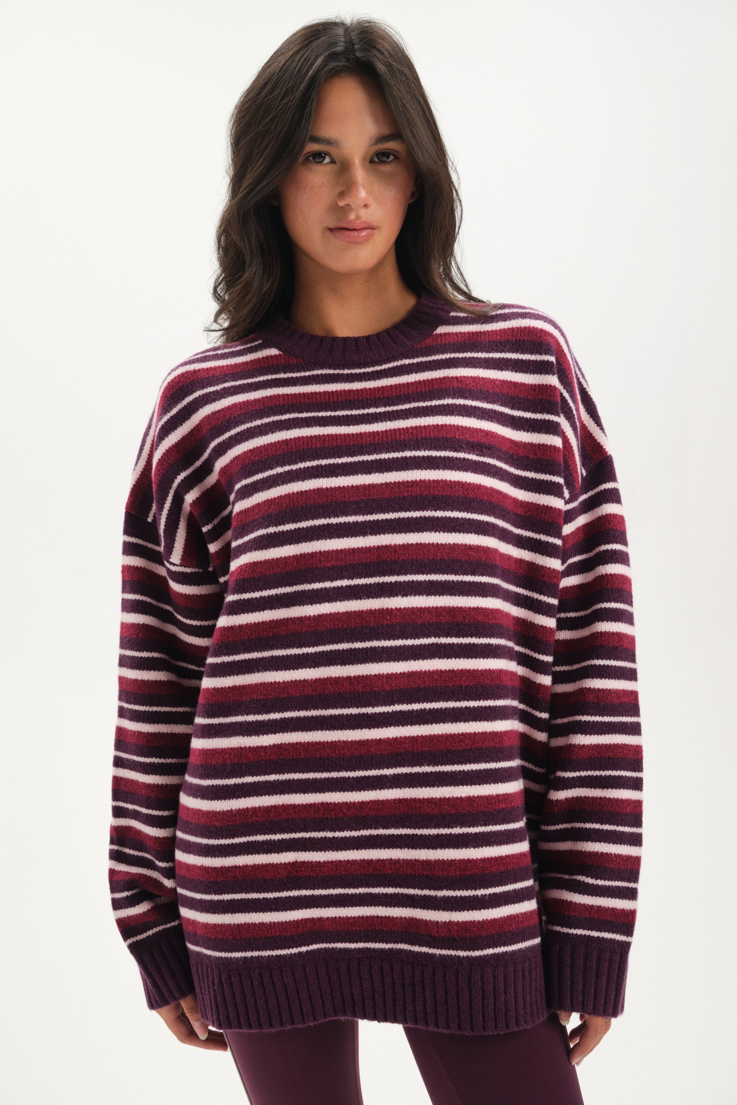 Woman wearing a striped sweater on a white background 