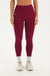 Woman wearing a maroon leggings on a white background <model-info>Bre wears a size M and is 5’7”, 25½" waist, 33” bust.</model-info>
