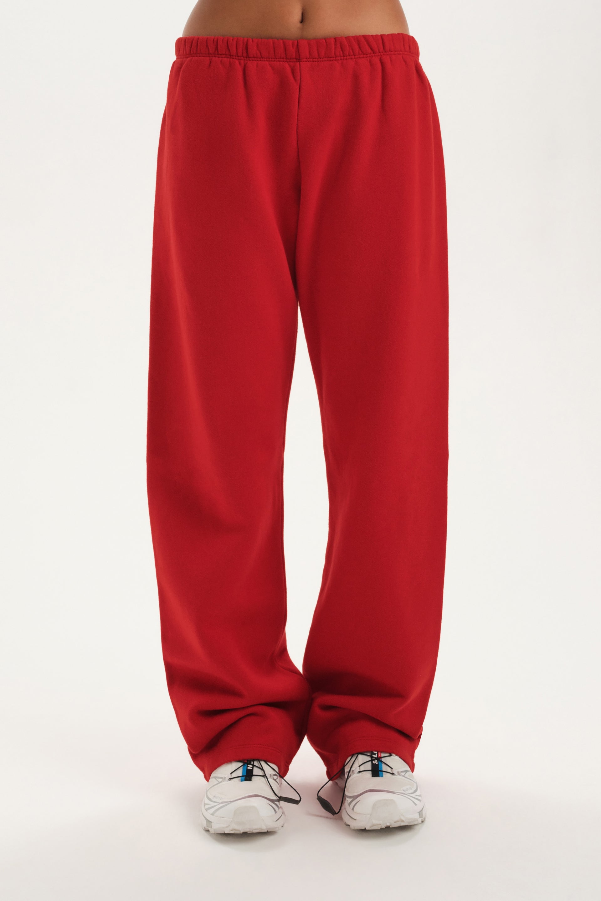 Red sweatpants worn by a person on a white background <model-info>Jelene wears a size XS and is 5’7”, 23” waist, 32AB bust.</model-info>