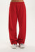 Red sweatpants worn by a person on a white background <model-info>Jelene wears a size XS and is 5’7”, 23” waist, 32AB bust.</model-info>