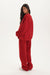 Person wearing a red tracksuit on a white background