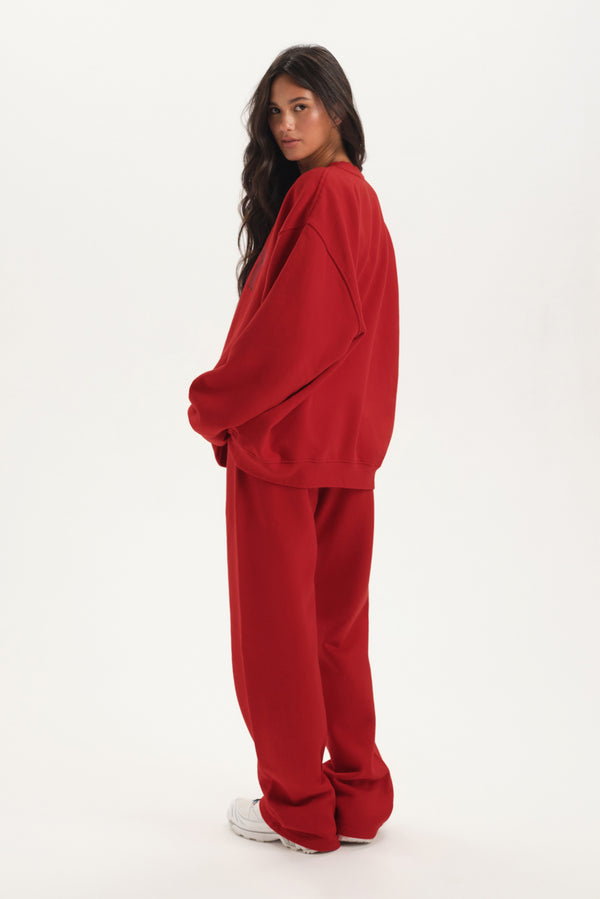 Person wearing a red tracksuit on a white background