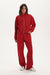 Person wearing a red tracksuit on a white background 