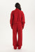 Person wearing a red tracksuit on a white background