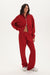 Person wearing a red tracksuit on a white background