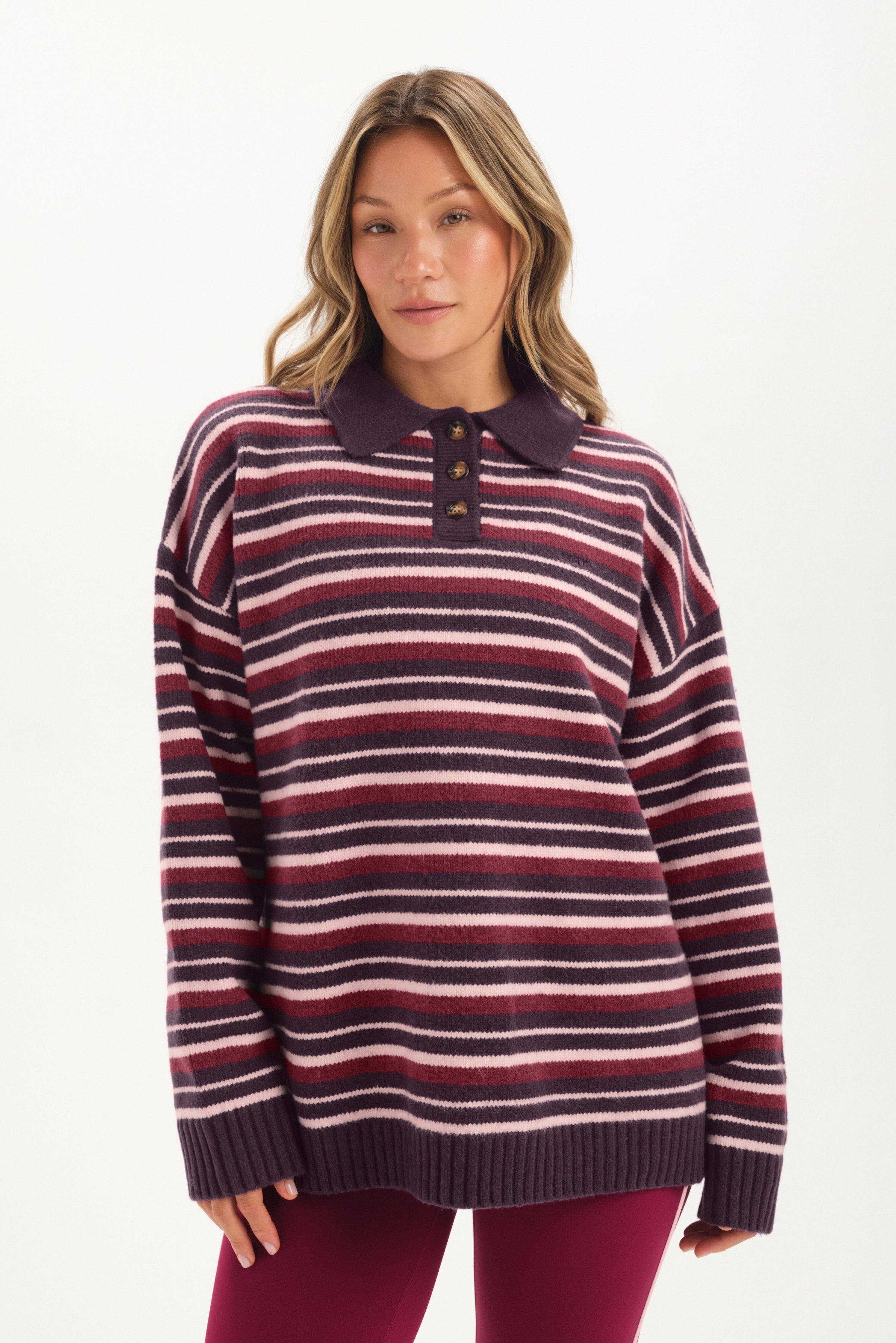 Woman wearing a striped sweater with a collar on a white background 