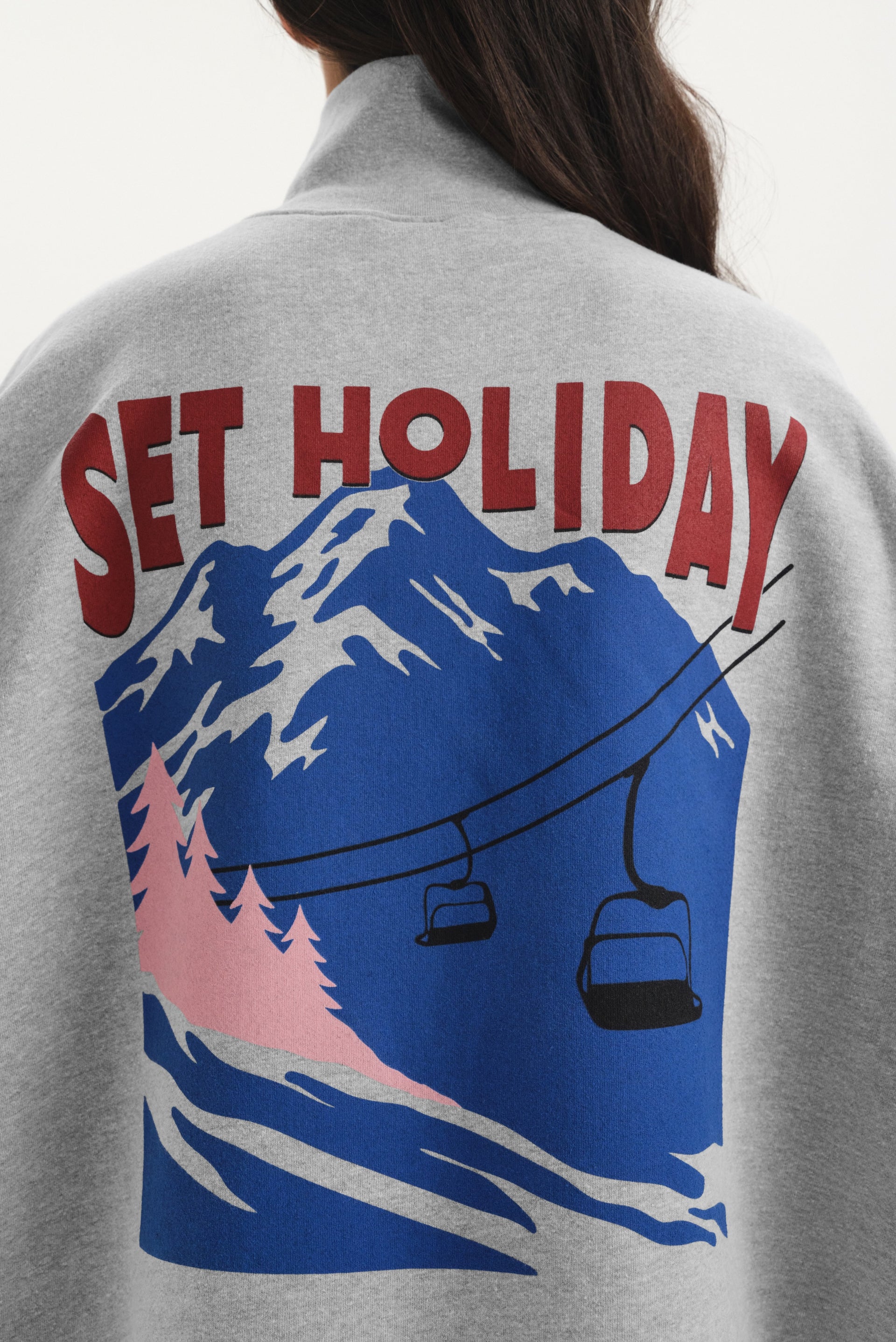 Gray sweatshirt with 'Set Holiday' graphic on the back