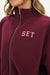 Maroon jacket with 'SET' text on a white background