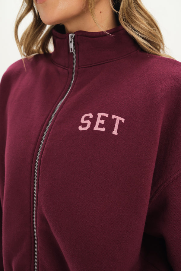 Maroon jacket with 'SET' text on a white background
