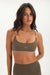 Woman wearing a green sports bra and leggings with 'SET' branding on a white background <model-info>Jelene wears a size XS and is 5’7”, 23” waist, 32AB bust.</model-info>