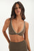 Woman wearing a green sports bra and leggings on a white background <model-info>Jelene wears a size XS and is 5’7”, 23” waist, 32AB bust.</model-info>