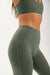 Green athletic leggings with a sports bra on a white background