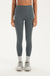 Woman wearing gray leggings on a white background <model-info>Jelene wears a size XS and is 5’7”, 23” waist, 32AB bust.</model-info>