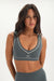 Woman wearing a gray sports bra and leggings with 'SET' branding on a white background <model-info>Jelene wears a size XS and is 5’7”, 23” waist, 32AB bust.</model-info>