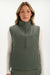 Woman wearing a green vest with a white background <model-info>Bre wears a size M and is 5’7”, 25½" waist, 33” bust.</model-info>