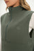 Green vest with a brand logo on a white background