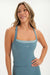 Woman wearing a blue athletic top with 'SET' logo on a white background <model-info>Bre wears a size S and is 5’7”, 25½" waist, 33” bust.</model-info>