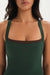 Green tank top with brown trim worn by a person on a white background