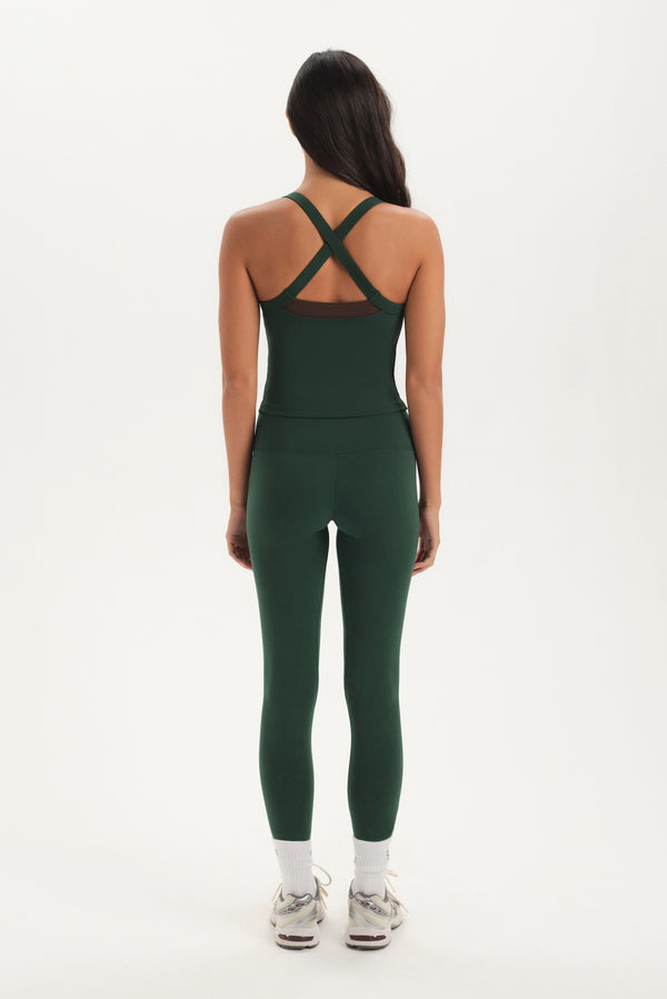 Person wearing a green athletic outfit on a white background