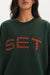 Green sweatshirt with plaid 'SET' design on a white background