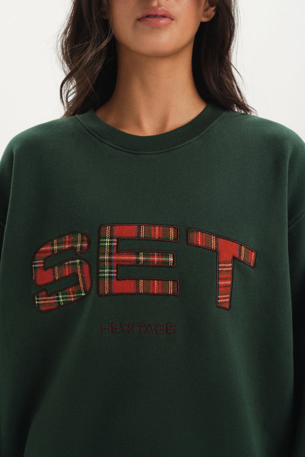 Green sweatshirt with plaid 'SET' design on a white background