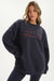 Person wearing a navy sweatshirt with a plaid design on a white background <model-info>Bre wears a size L and is 5’7”, 25½" waist, 33” bust.</model-info>