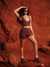 Woman in athletic wear standing against a red rock wall