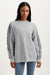 Woman wearing a gray sweatshirt with striped sleeves on a white background <model-info>Sydney wears a size L and is 5’9, 24½” waist, 32B bust.</model-info>
